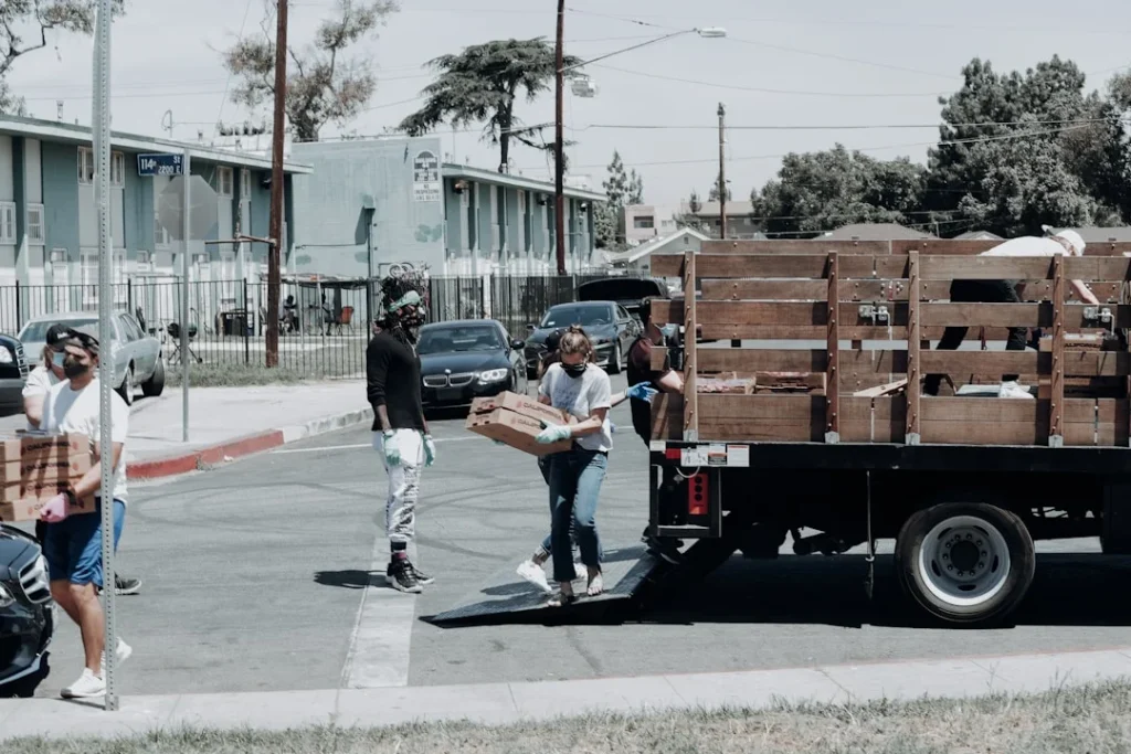 Volunteers distributing goods following a successful text messaging campaign by nonprofits, enabling them to reach a wide audience